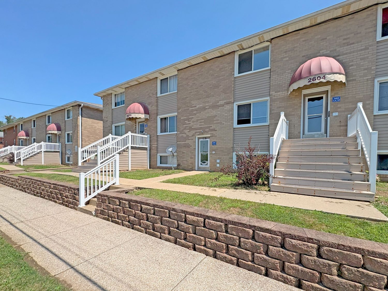 Regency Apartments of Canton exterior with new entries, retaining wall and landscaping.